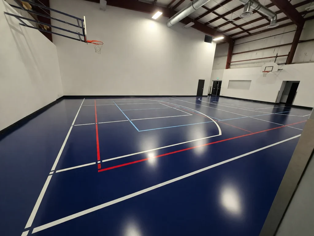 Epoxy & Polyaspartic Flooring Project Gallery in Southern Ontario 5 Industrial basketball court with glossy resinous floor coating