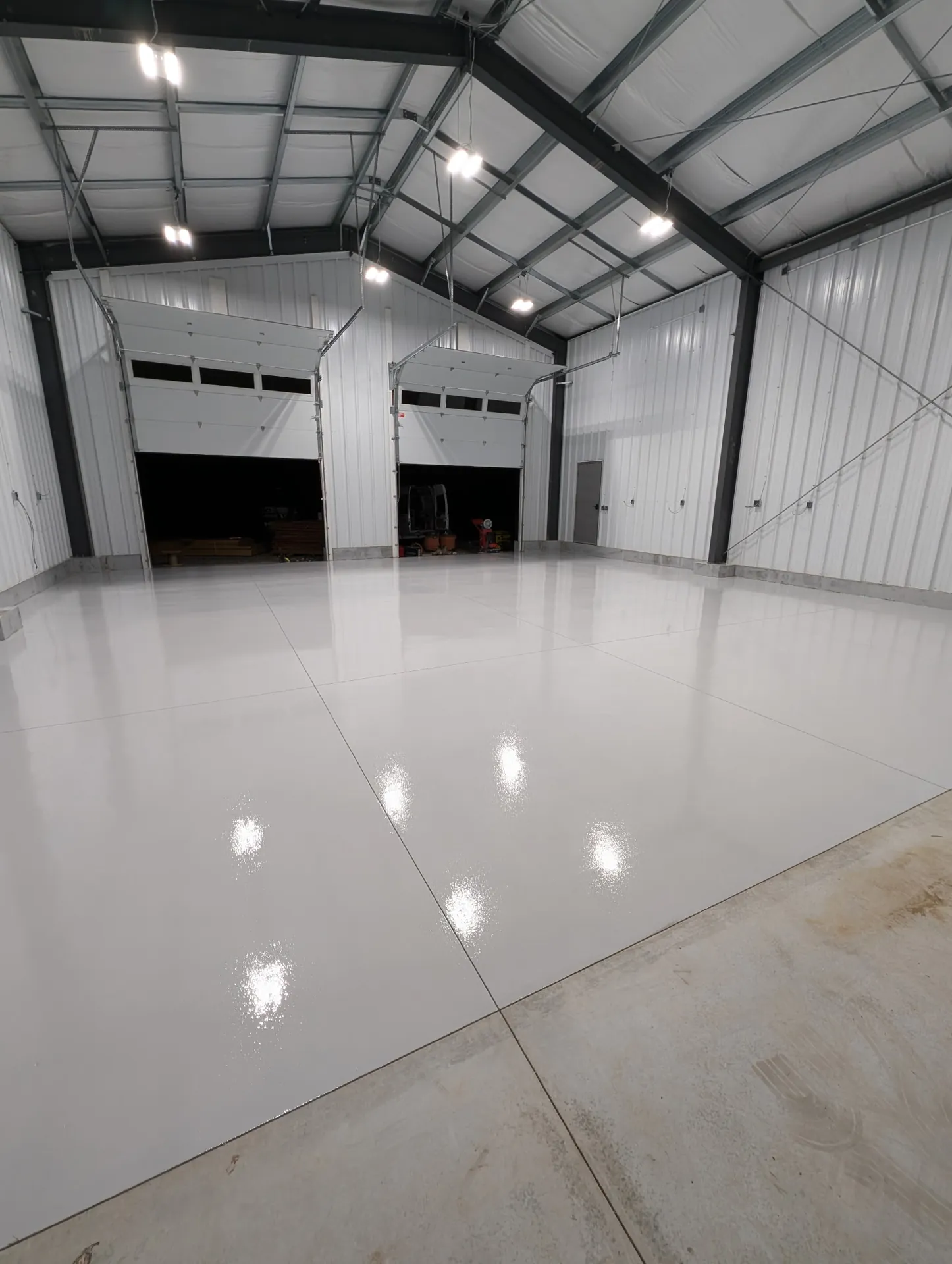 Finished light grey floor inside a Burlington commercial work bay