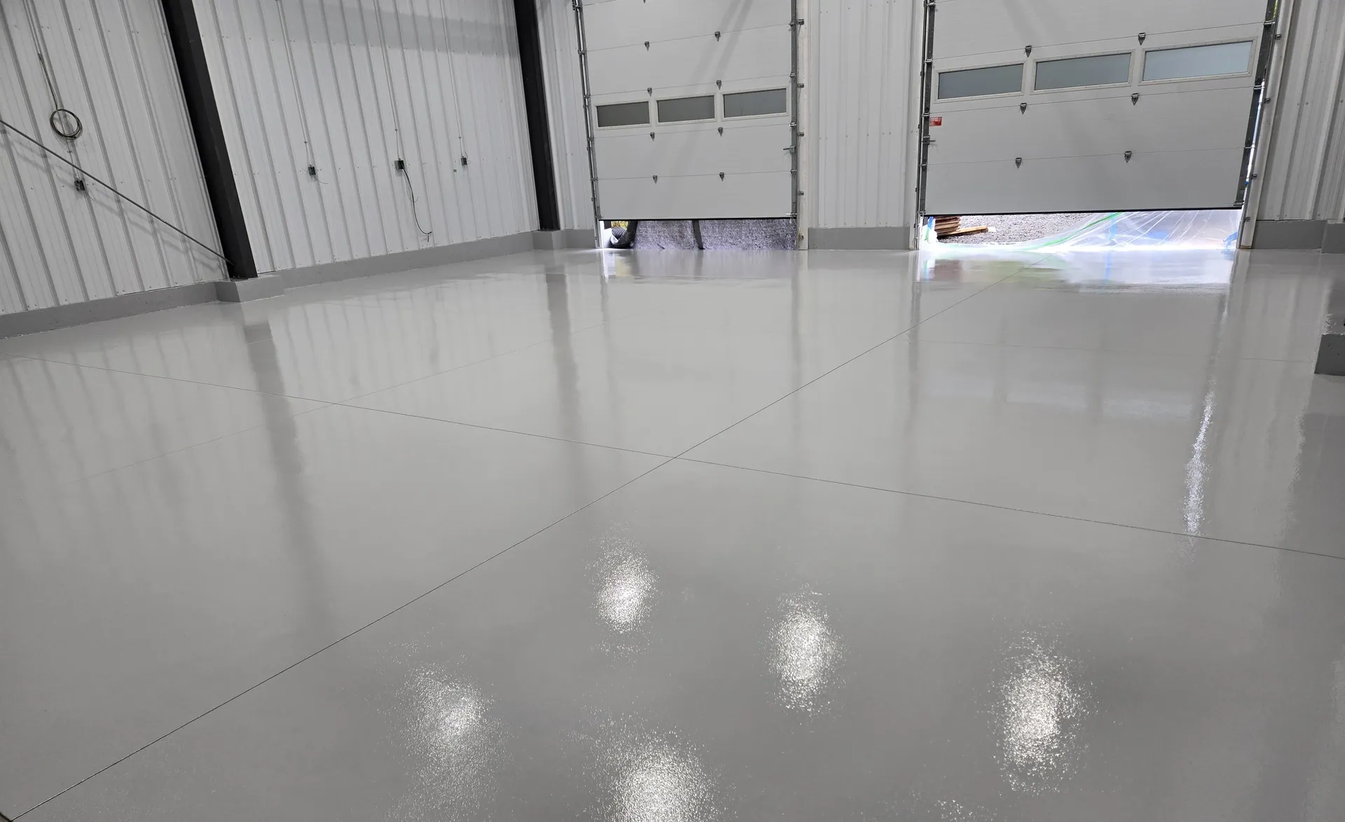Light grey high-build floor across a multi-bay Burlington commercial facility