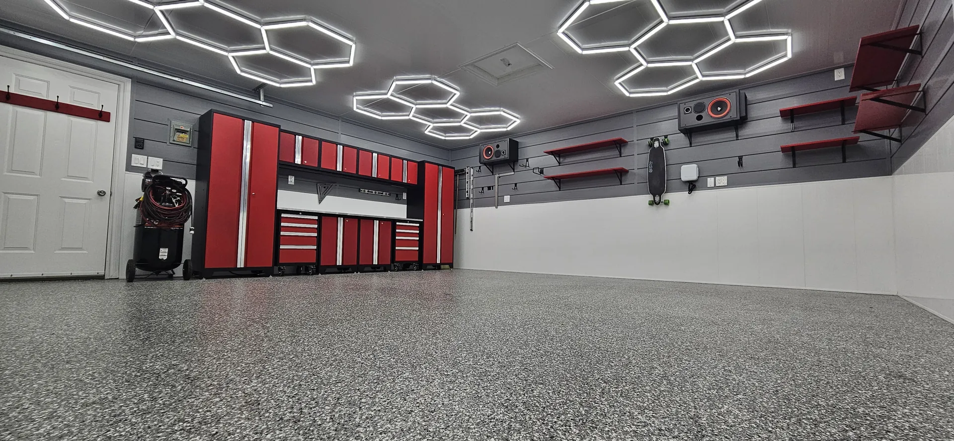 Finished Burlington garage workshop with a fine grey flake floor and red cabinetry