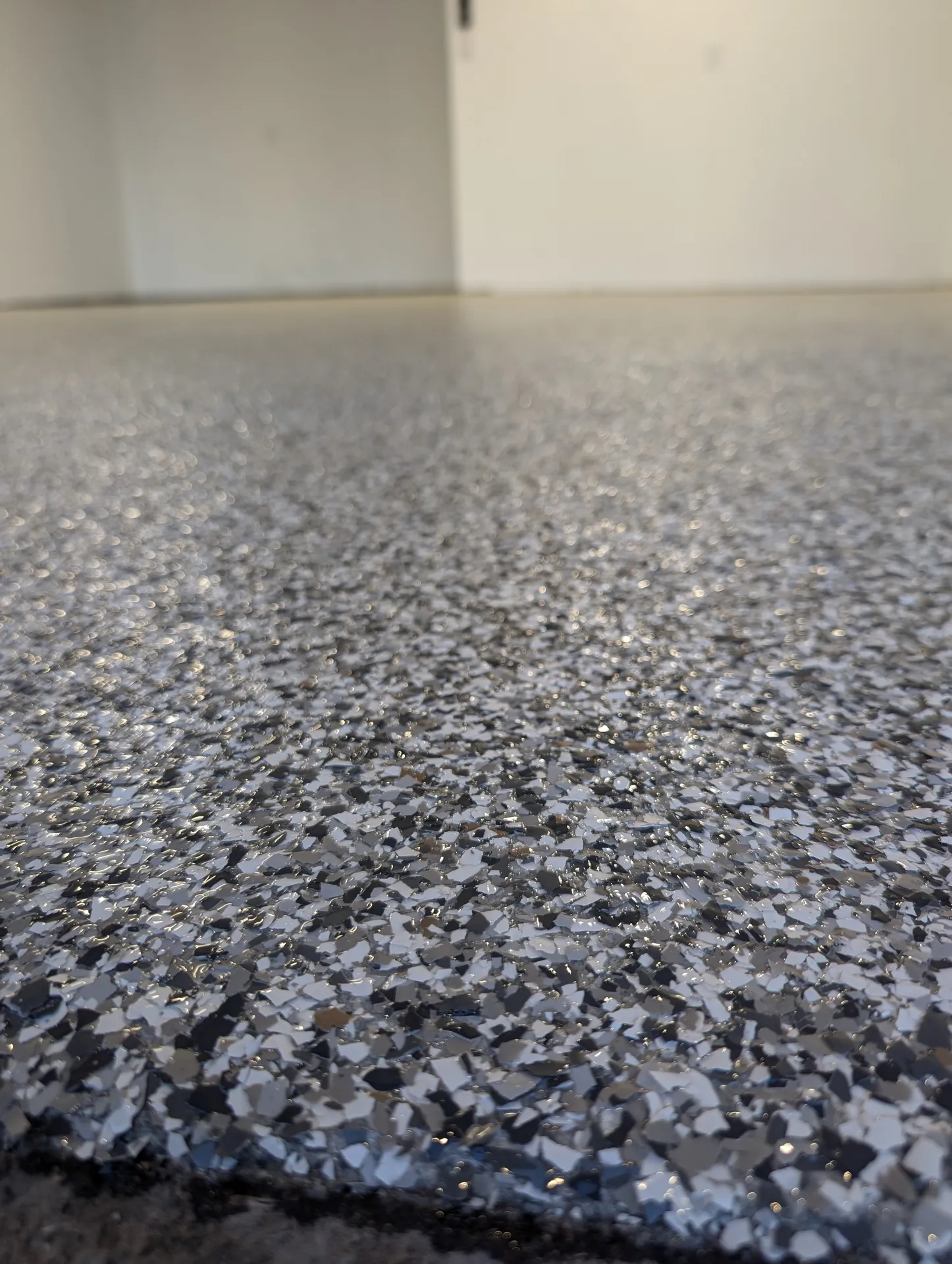 White and grey flake texture on a Burlington residential garage floor