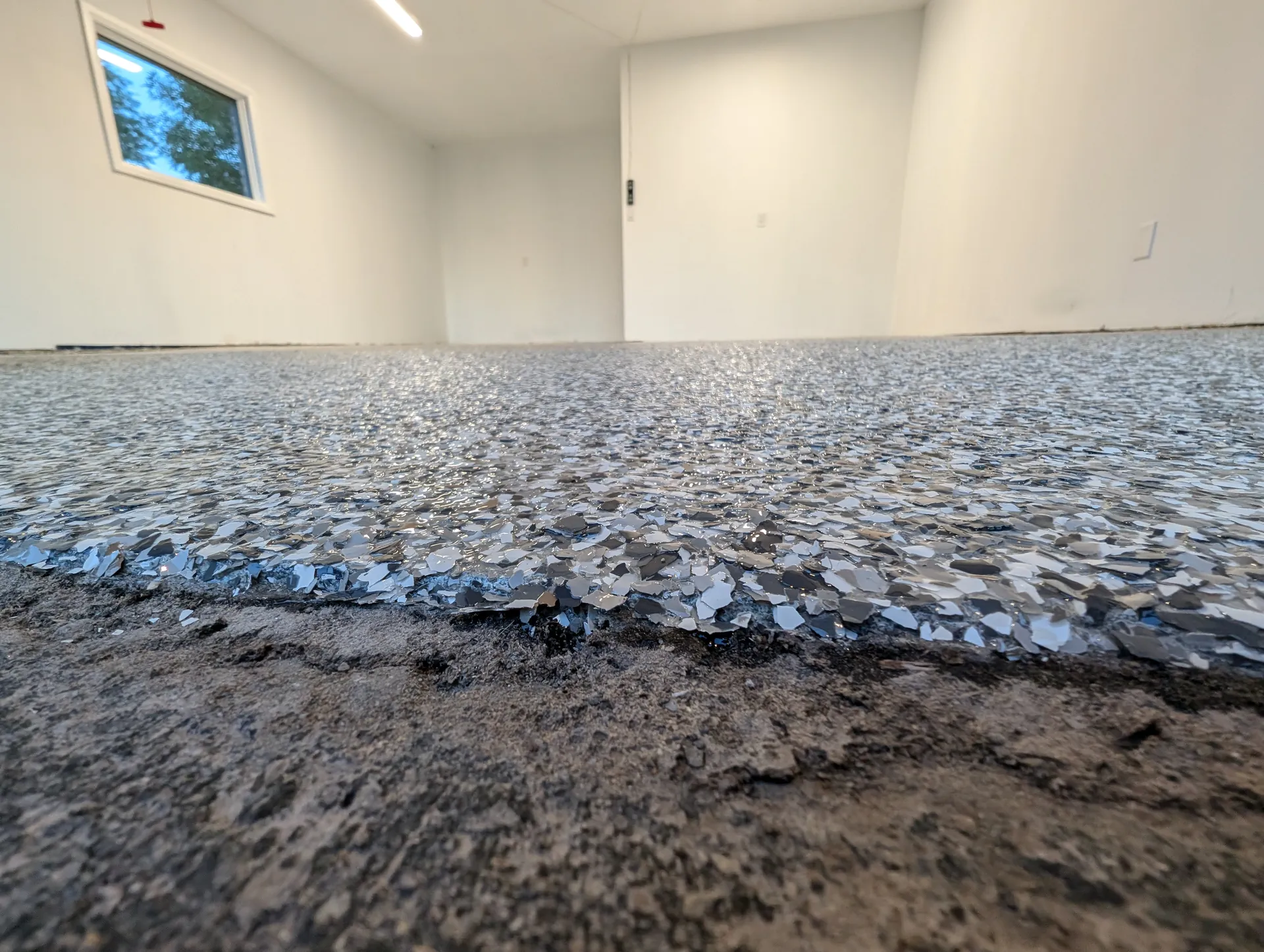 Bright light grey flake floor across a Burlington two-car garage