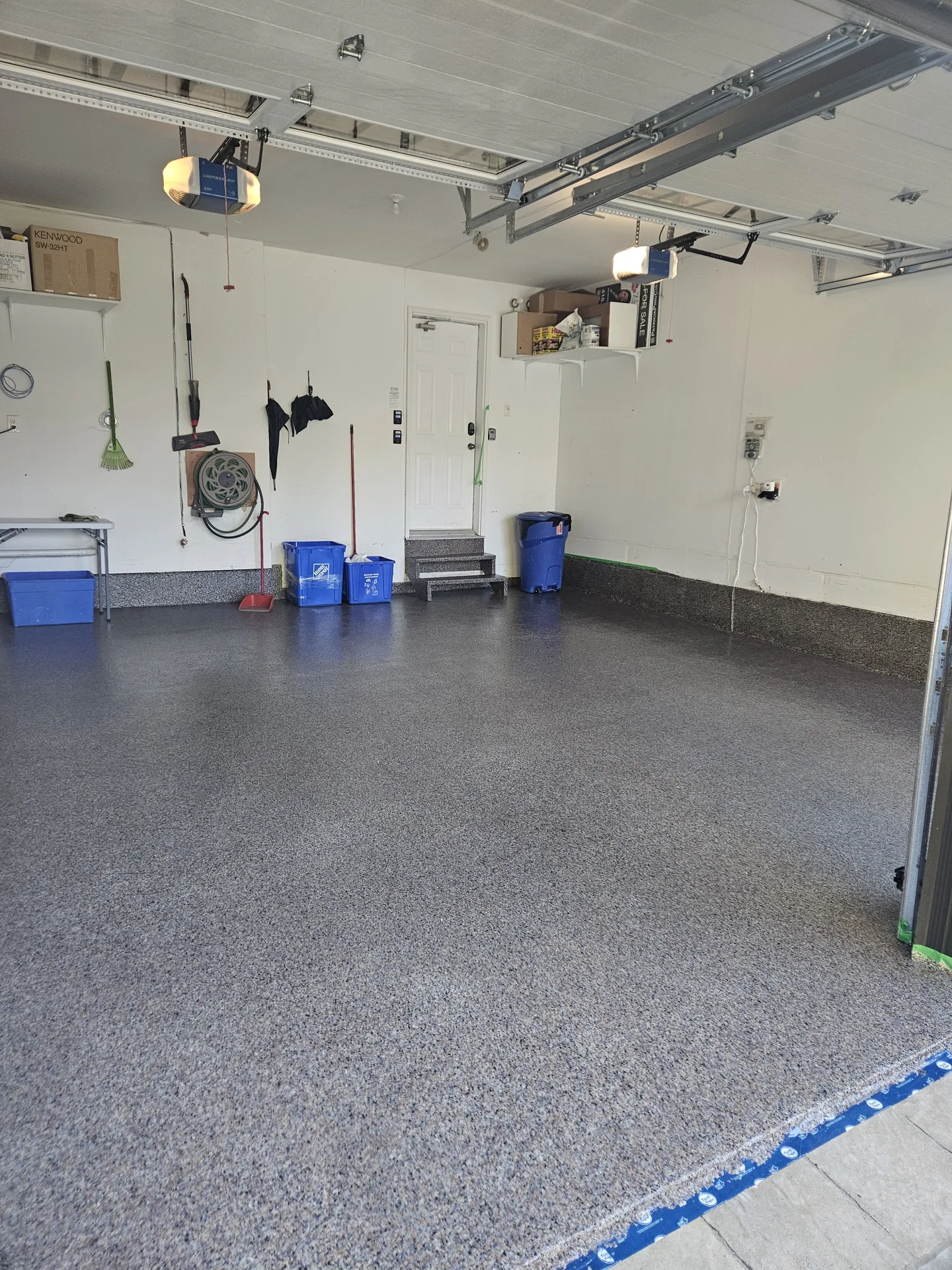 Epoxy & Polyaspartic Flooring in Oakville, ON 2 Medium grey decorative flake floor with coated steps in an Oakville working garage