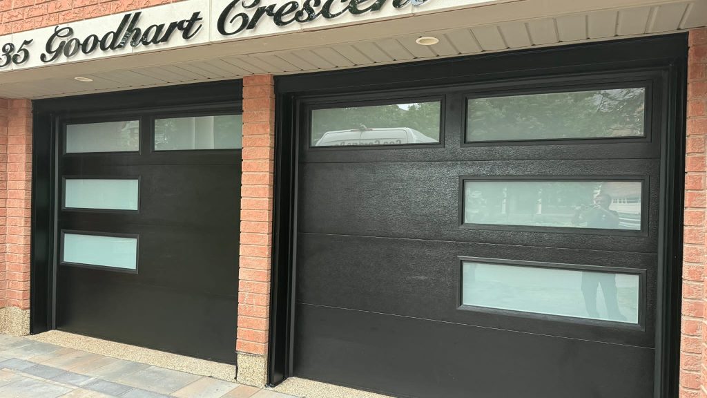 Black double garage doors with rectangular window panels