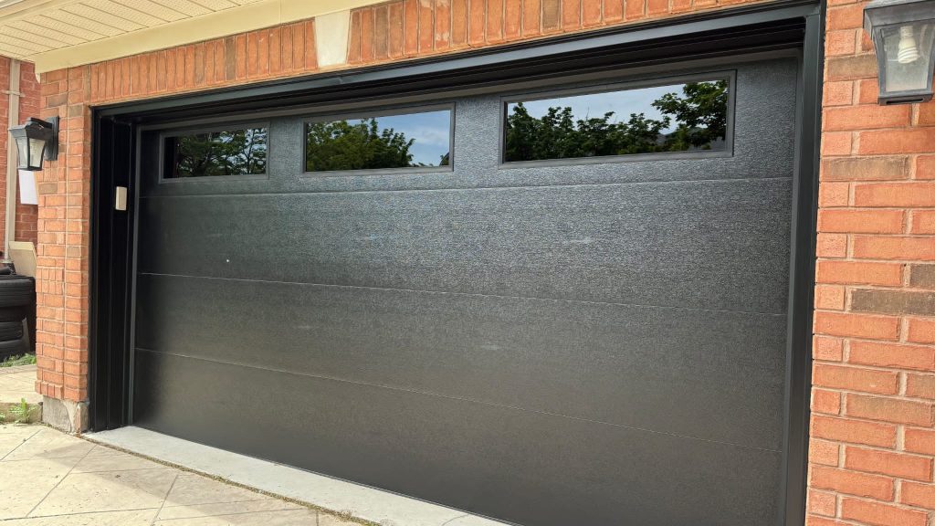 Black single garage door with three upper windows